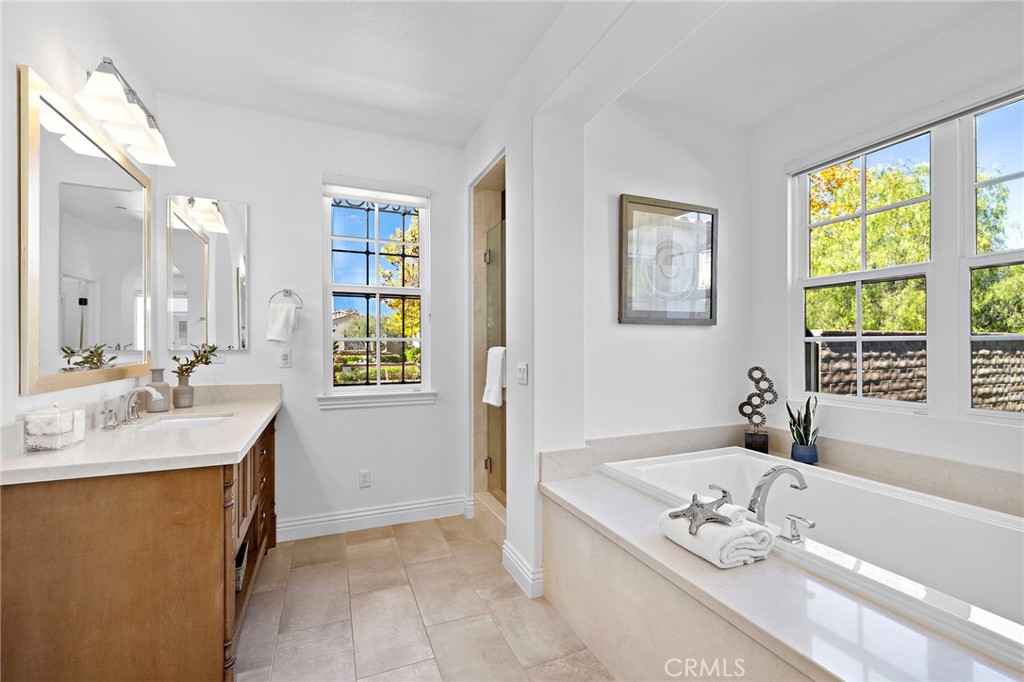 4 Gaucho Road Ladera Ranch, CA 92694 - Photo 21 of 40 a bathroom with a granite countertop sink a bathtub and next to a window