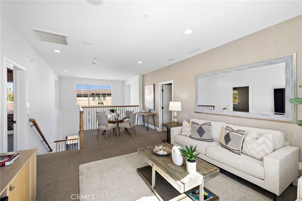4 Gaucho Road Ladera Ranch, CA 92694 - Photo 23 of 40 a living room with furniture kitchen view and a wooden floor