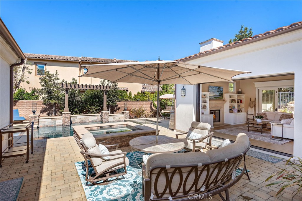 4 Gaucho Road Ladera Ranch, CA 92694 - Photo 6 of 40 a view of a patio with table and chairs under an umbrella