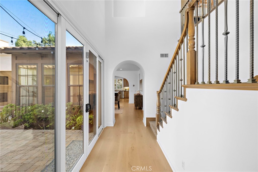 4 Gaucho Road Ladera Ranch, CA 92694 - Photo 7 of 40 a view of a hallway with wooden floor and staircase