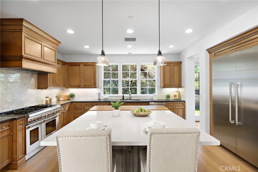4 Gaucho Road Ladera Ranch, CA 92694 - Photo 9 of 40 a kitchen that has a sink a stove and chairs
