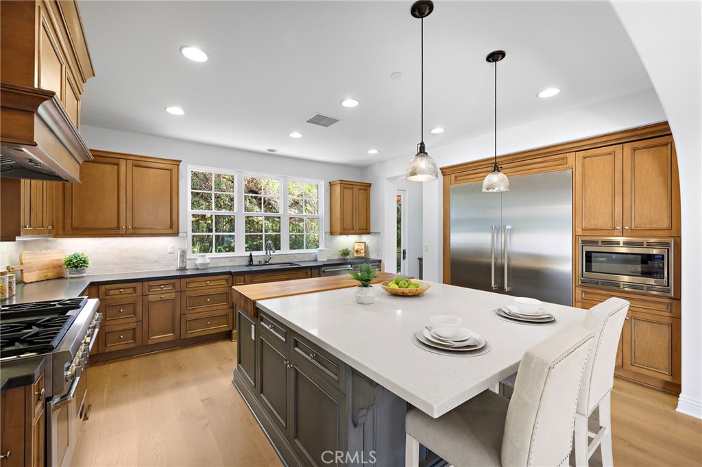 4 Gaucho Road Ladera Ranch, CA 92694 - Photo 10 of 40 a kitchen with stainless steel appliances granite countertop a sink a stove and a refrigerator