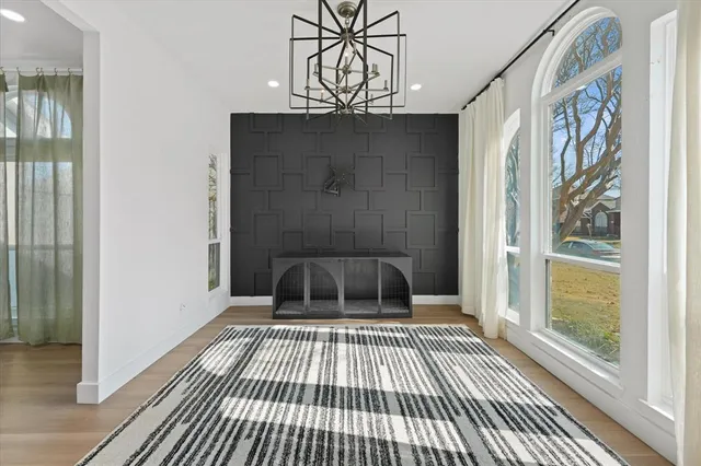a view of a bedroom with wooden floor and windows