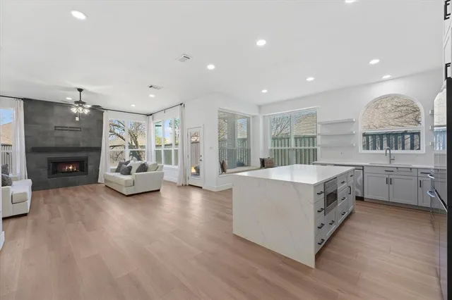 a large white kitchen with a large window