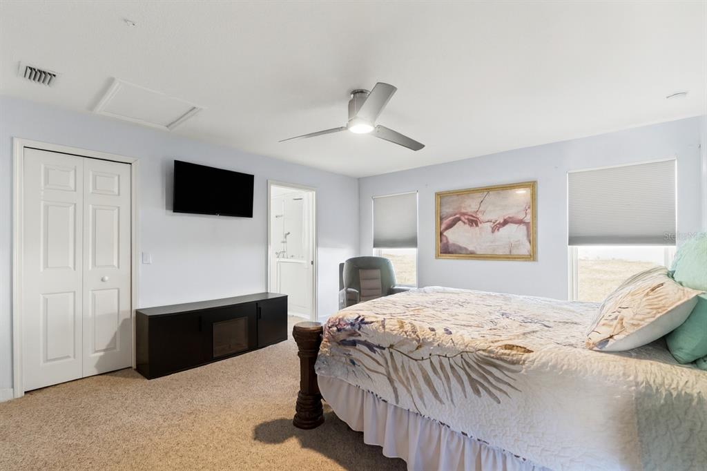 15819 Southwest 13th Circle Ocala, FL 34473 - Photo 14 of 34 a bedroom with a bed and a flat screen tv