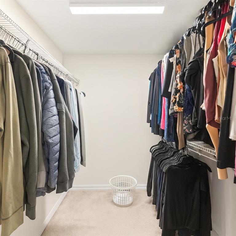 15819 Southwest 13th Circle Ocala, FL 34473 - Photo 18 of 34 a view of walk in closet with clothes and shoes