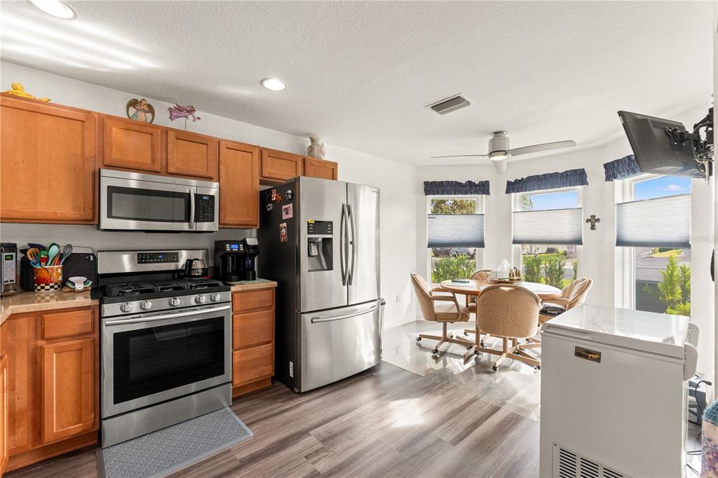 15819 Southwest 13th Circle Ocala, FL 34473 - Photo 8 of 34 a kitchen with a stove a refrigerator and a fireplace