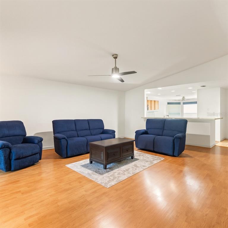 15819 Southwest 13th Circle Ocala, FL 34473 - Photo 10 of 34 a living room with furniture and a chandelier