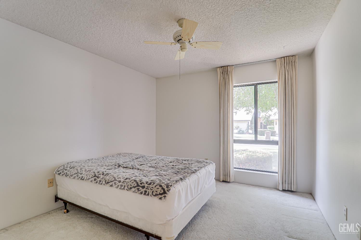 Undisclosed Address Bakersfield, CA 93309 - Photo 13 of 37 a bedroom with a bed and a window