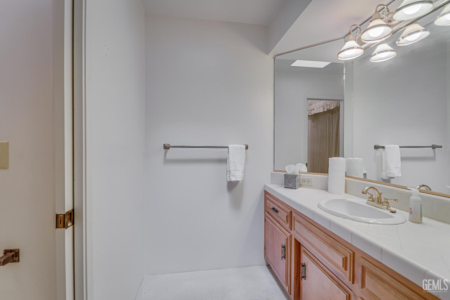 Undisclosed Address Bakersfield, CA 93309 - Photo 15 of 37 a bathroom with a sink a vanity and a mirror