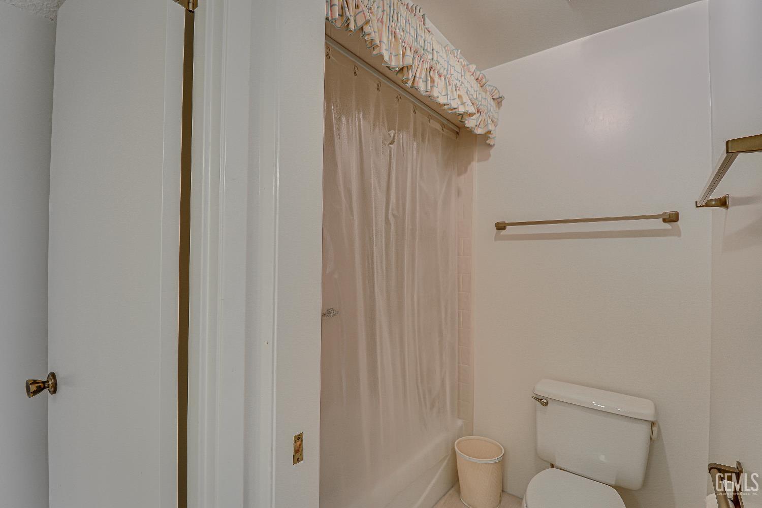 Undisclosed Address Bakersfield, CA 93309 - Photo 16 of 37 a bathroom with a toilet and a shower