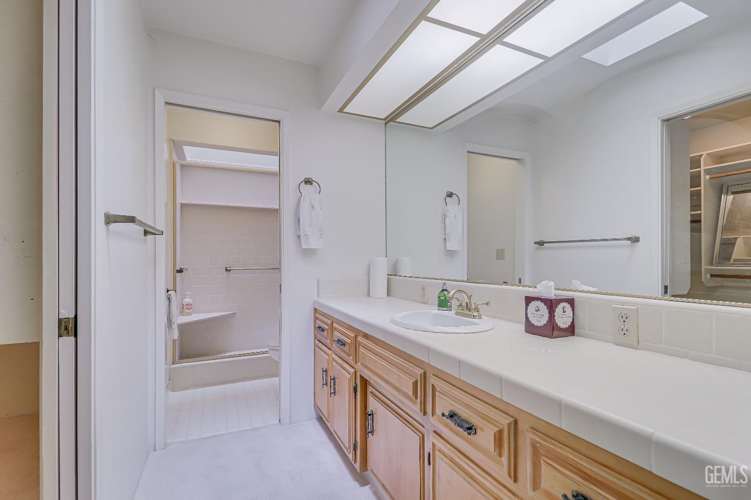 Undisclosed Address Bakersfield, CA 93309 - Photo 19 of 37 a bathroom with a sink and a mirror