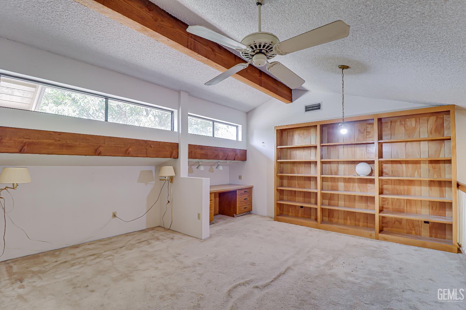 Undisclosed Address Bakersfield, CA 93309 - Photo 23 of 37 a view of an empty room with a fireplace and cabinet