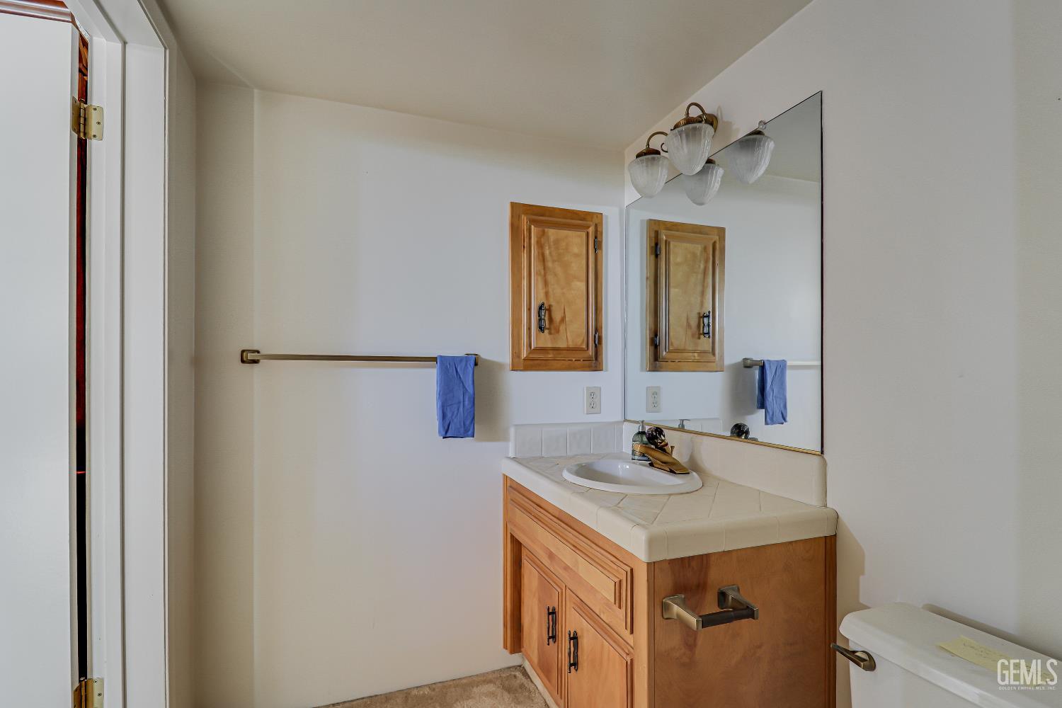 Undisclosed Address Bakersfield, CA 93309 - Photo 25 of 37 a bathroom with a sink and a mirror