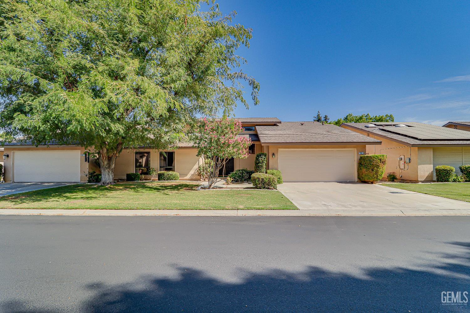 Undisclosed Address Bakersfield, CA 93309 - Photo 3 of 37 a front view of a house with a yard and a garage