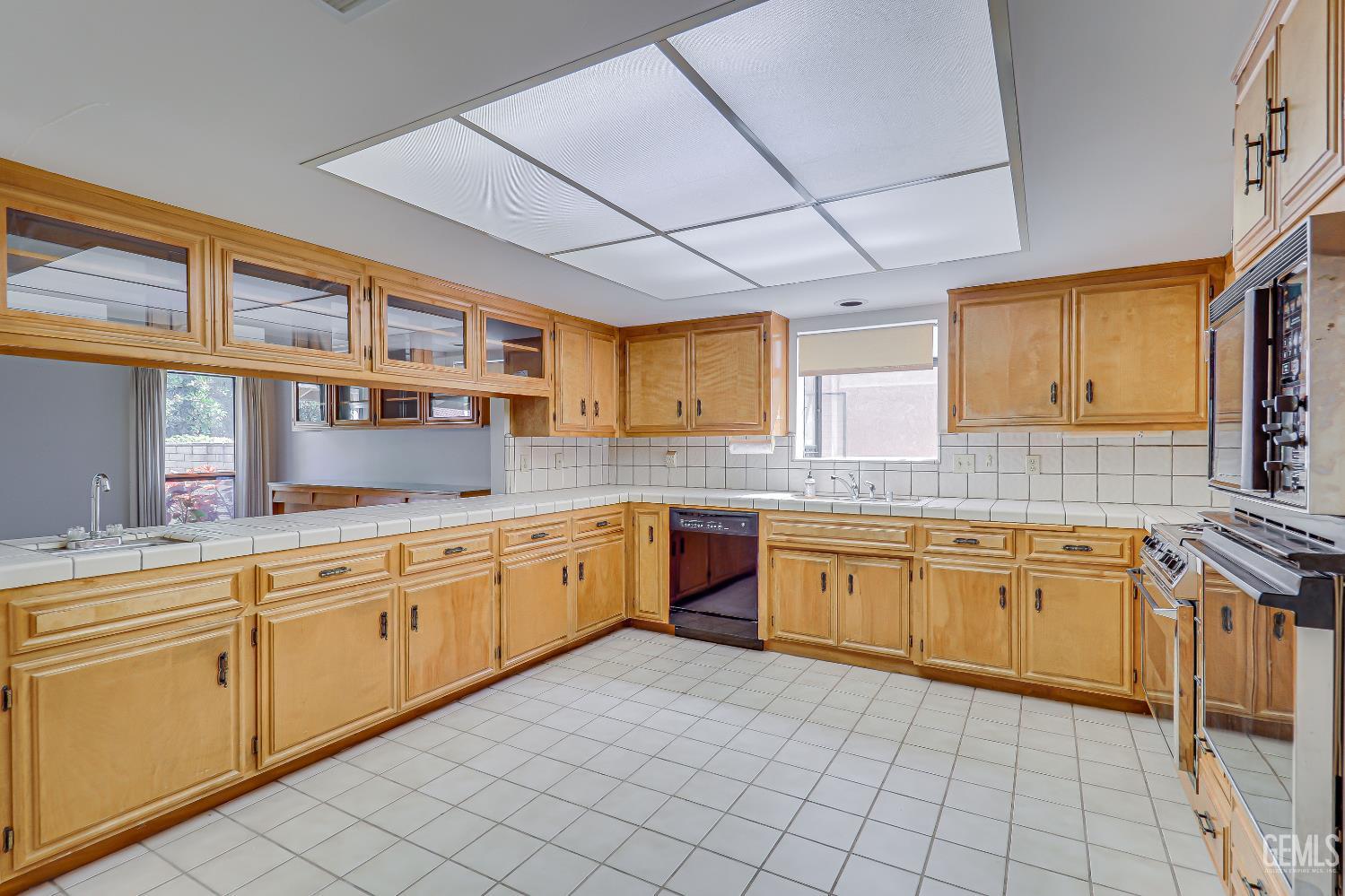 Undisclosed Address Bakersfield, CA 93309 - Photo 32 of 37 a large kitchen with stainless steel appliances granite countertop a sink and cabinets