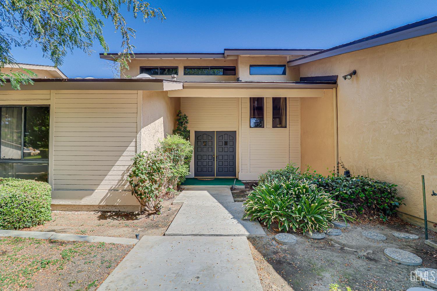 Undisclosed Address Bakersfield, CA 93309 - Photo 5 of 37 a front view of a house with garden