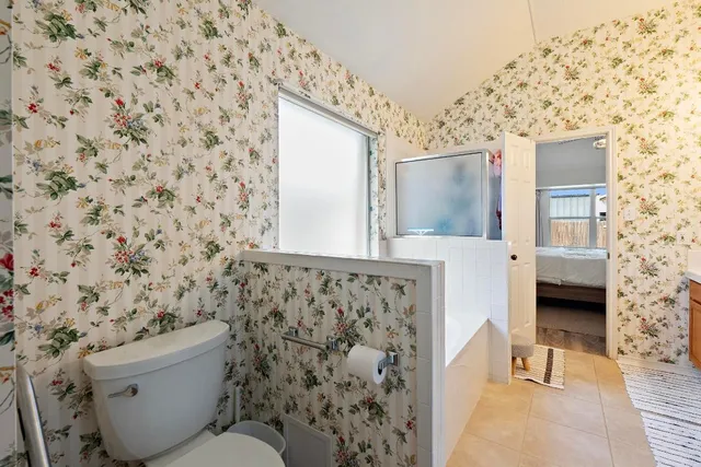 a bathroom with a toilet and a shower curtain