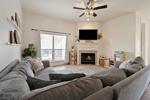 a living room with furniture fireplace and flat screen tv