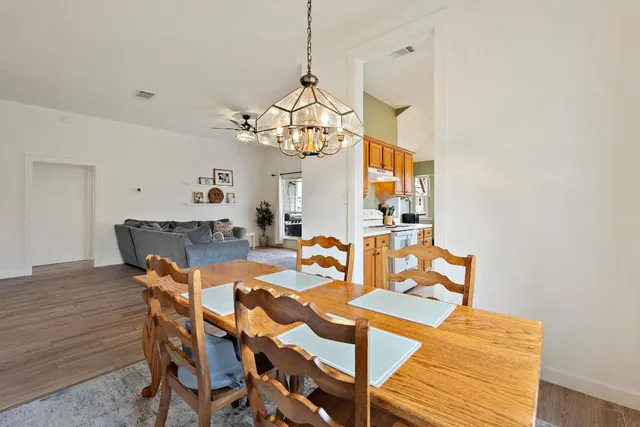 a view of a dining room with furniture and wooden floor