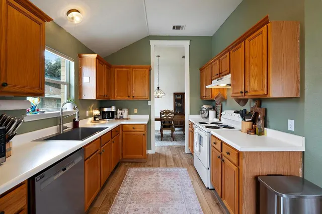 a kitchen with a sink stove and cabinets