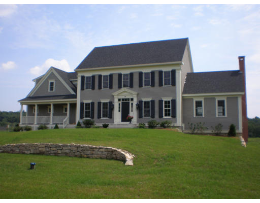 Lot 2 Adams Road Grafton, MA 01519 - Photo 1 of 26 a front view of a house with a garden