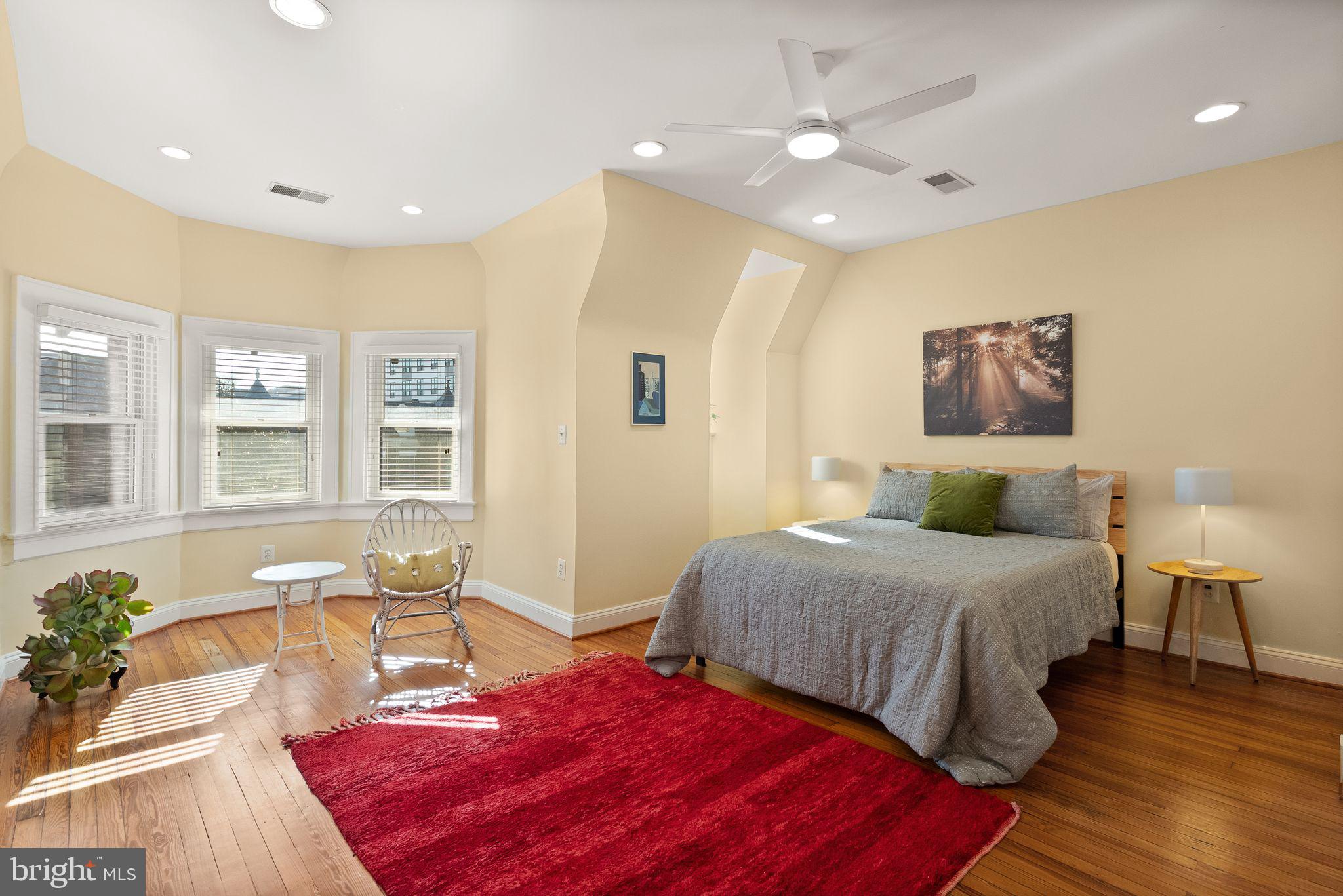 1335 Harvard Street Northwest, Unit PH2 Washington, DC 20009 - Photo 12 of 34 a spacious bedroom with a bed a table and chair