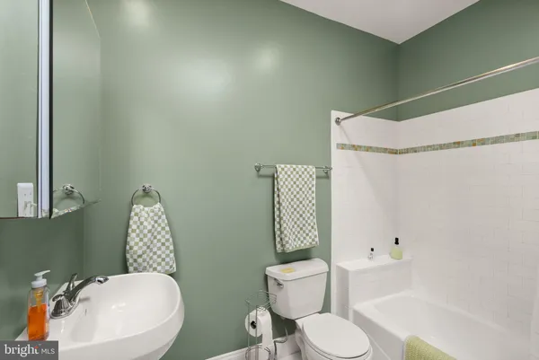 a white toilet sitting next to a bathroom sink and shower