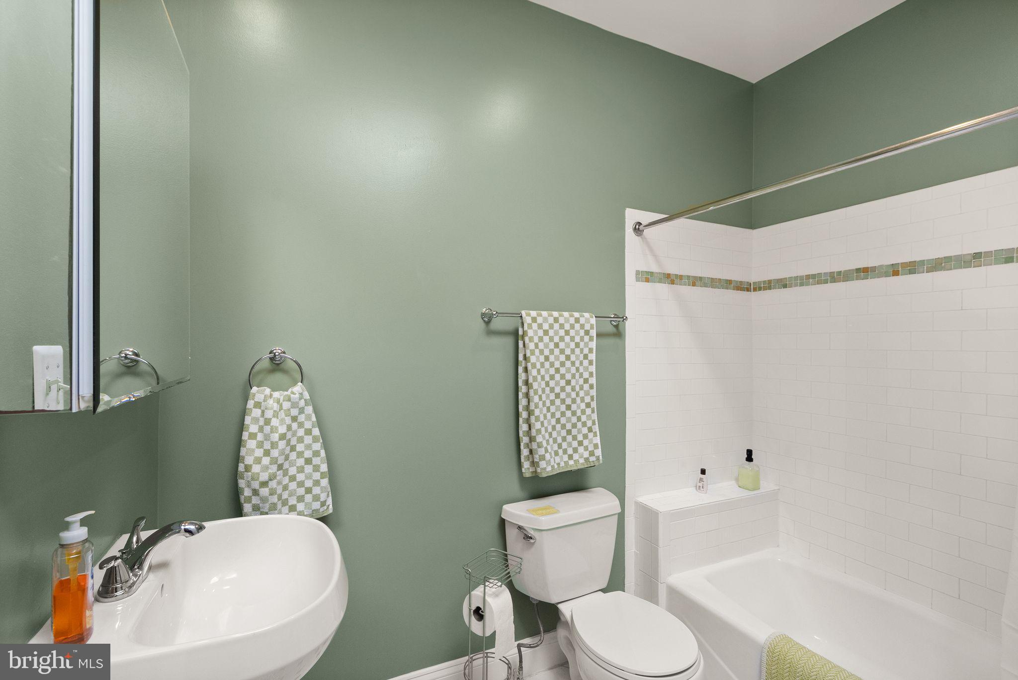 1335 Harvard Street Northwest, Unit PH2 Washington, DC 20009 - Photo 15 of 34 a white toilet sitting next to a bathroom sink and shower