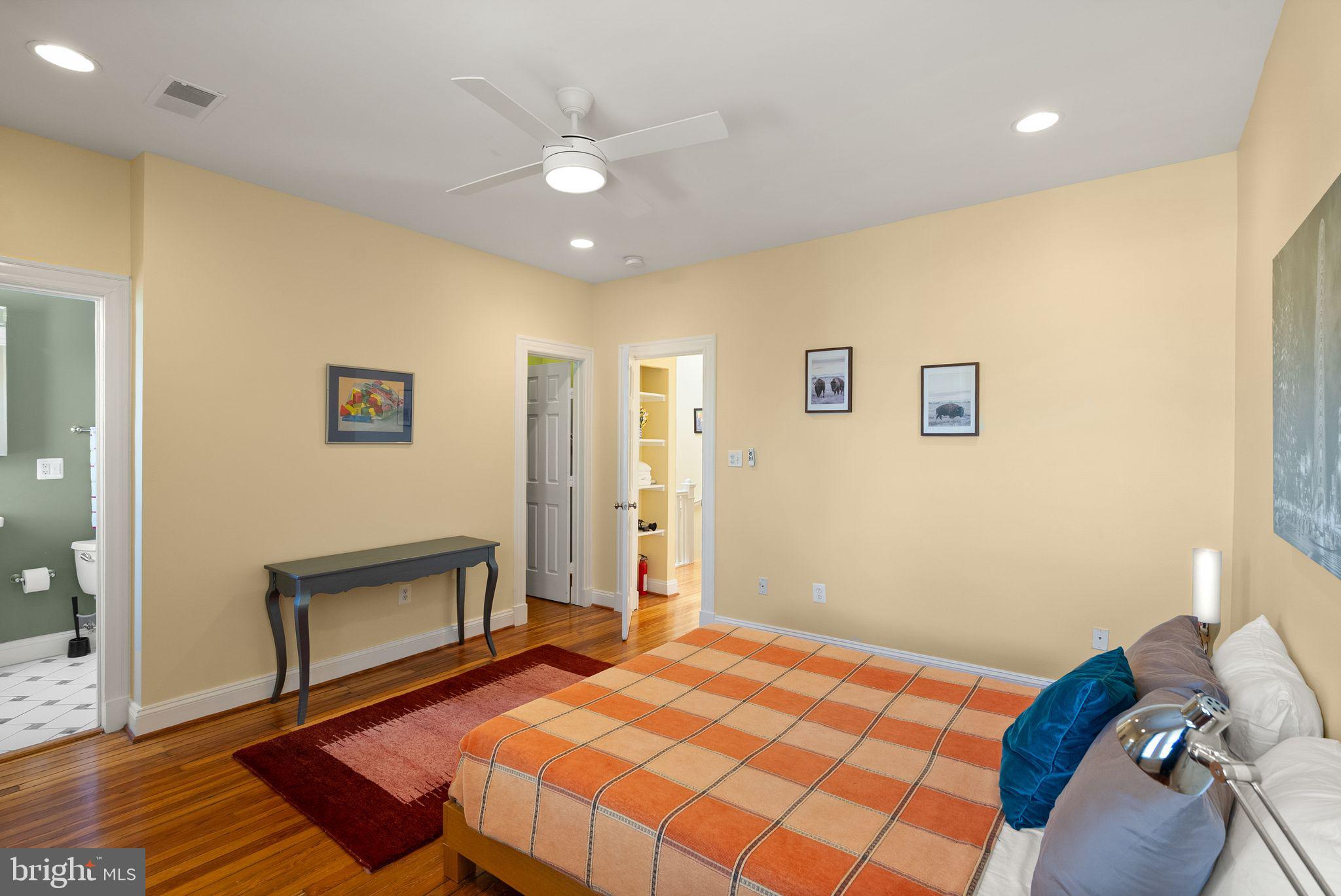 1335 Harvard Street Northwest, Unit PH2 Washington, DC 20009 - Photo 18 of 34 a bedroom with a bed and a view of livingroom with wooden floor