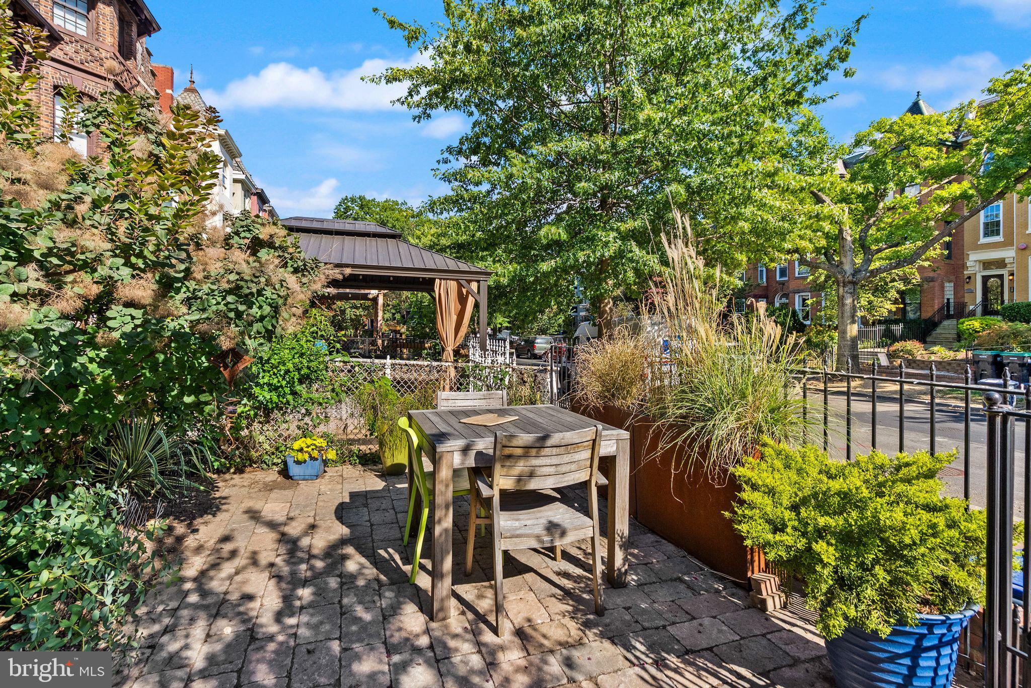 1335 Harvard Street Northwest, Unit PH2 Washington, DC 20009 - Photo 4 of 34 a view of a patio with table and chairs and potted plants