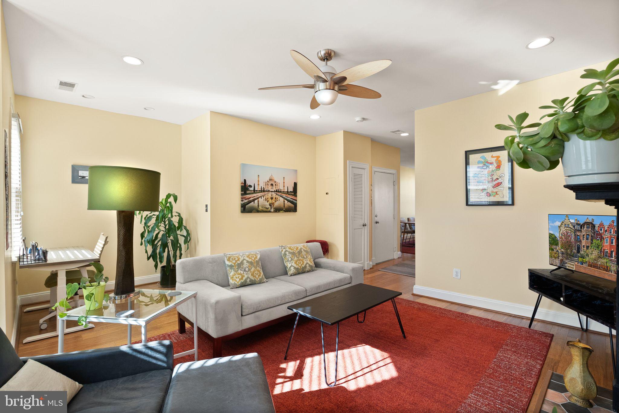 1335 Harvard Street Northwest, Unit PH2 Washington, DC 20009 - Photo 6 of 34 a living room with furniture and a flat screen tv