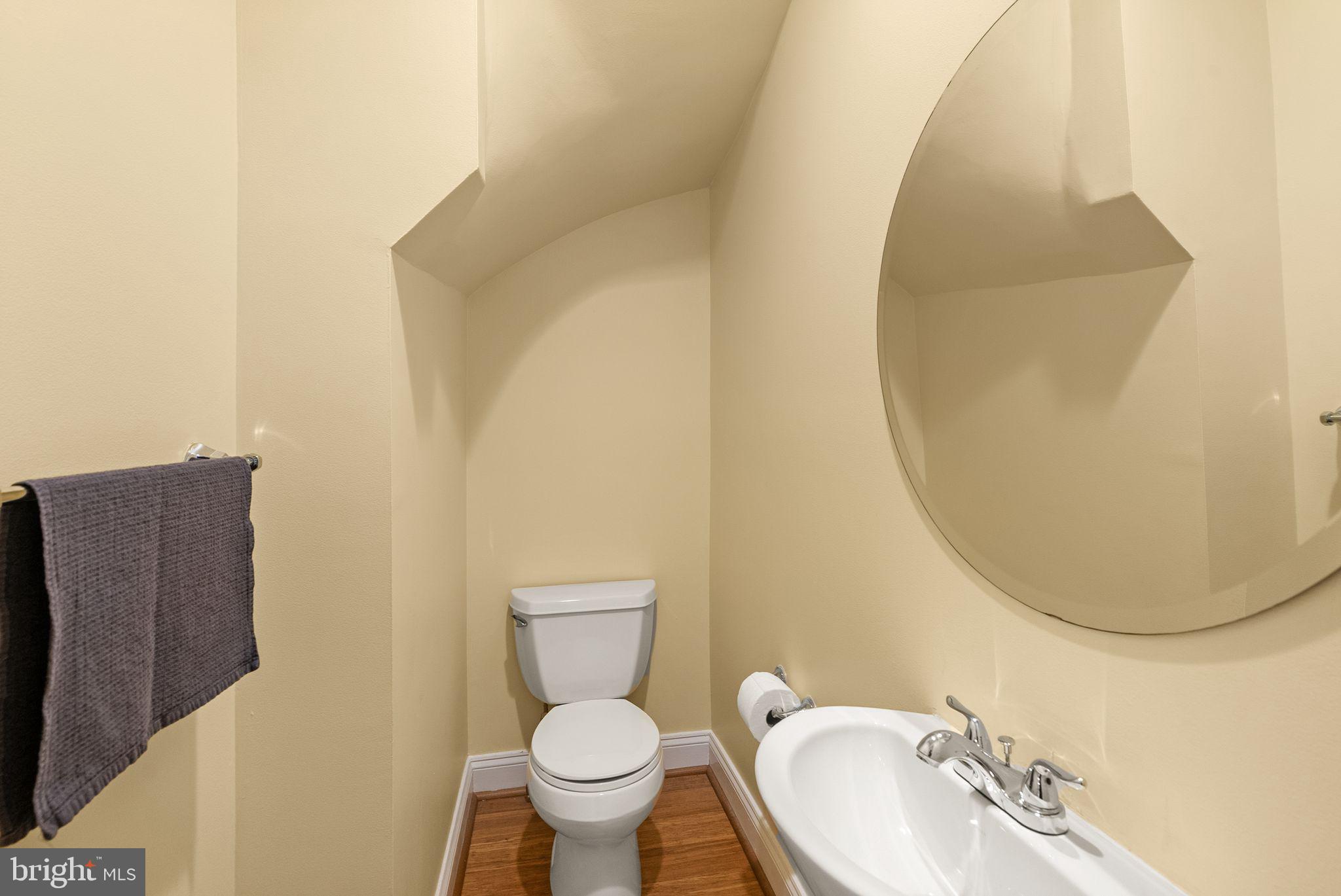 1335 Harvard Street Northwest, Unit PH2 Washington, DC 20009 - Photo 7 of 34 a bathroom with a toilet sink and mirror