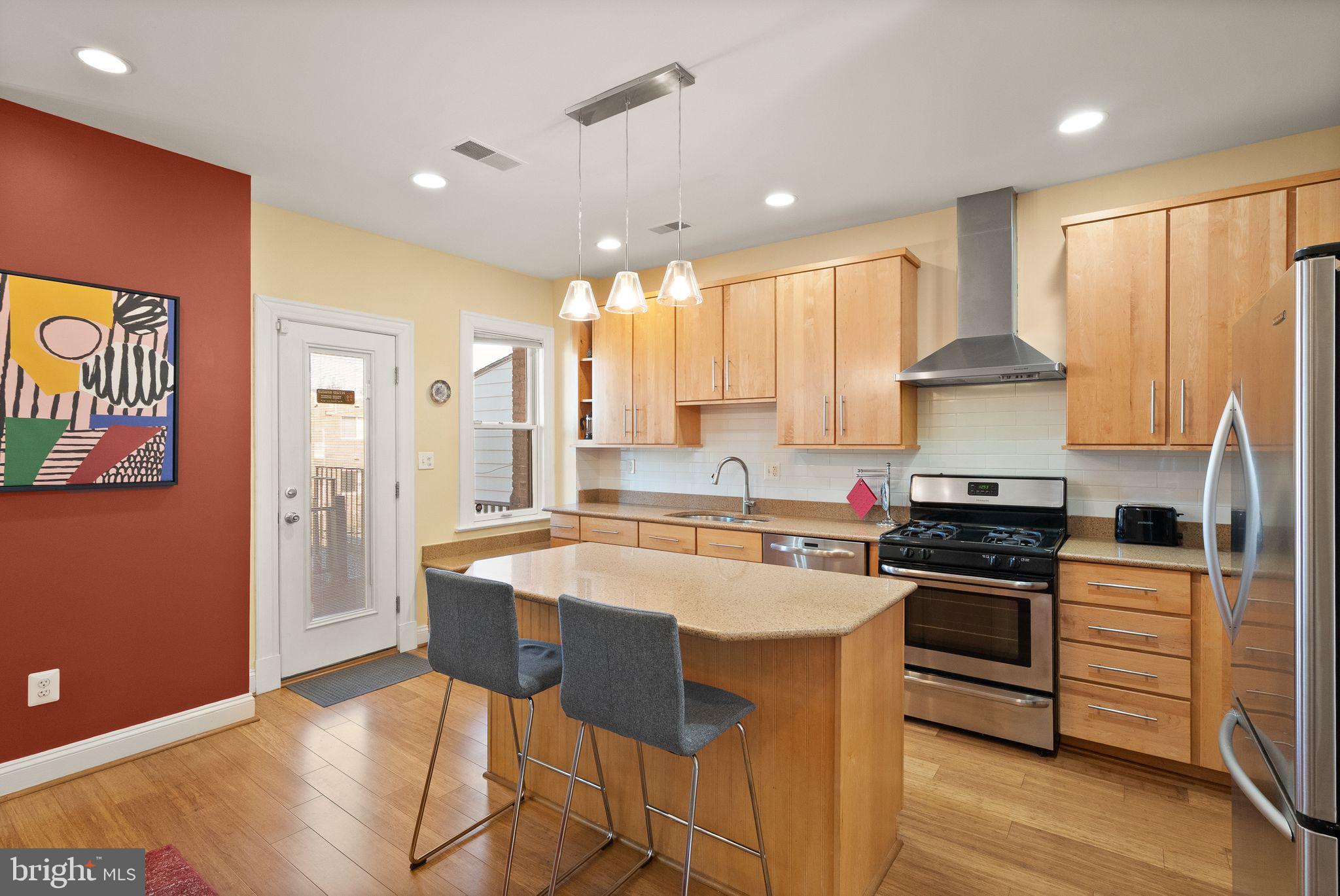 1335 Harvard Street Northwest, Unit PH2 Washington, DC 20009 - Photo 8 of 34 a kitchen with stainless steel appliances granite countertop a stove a sink and a refrigerator