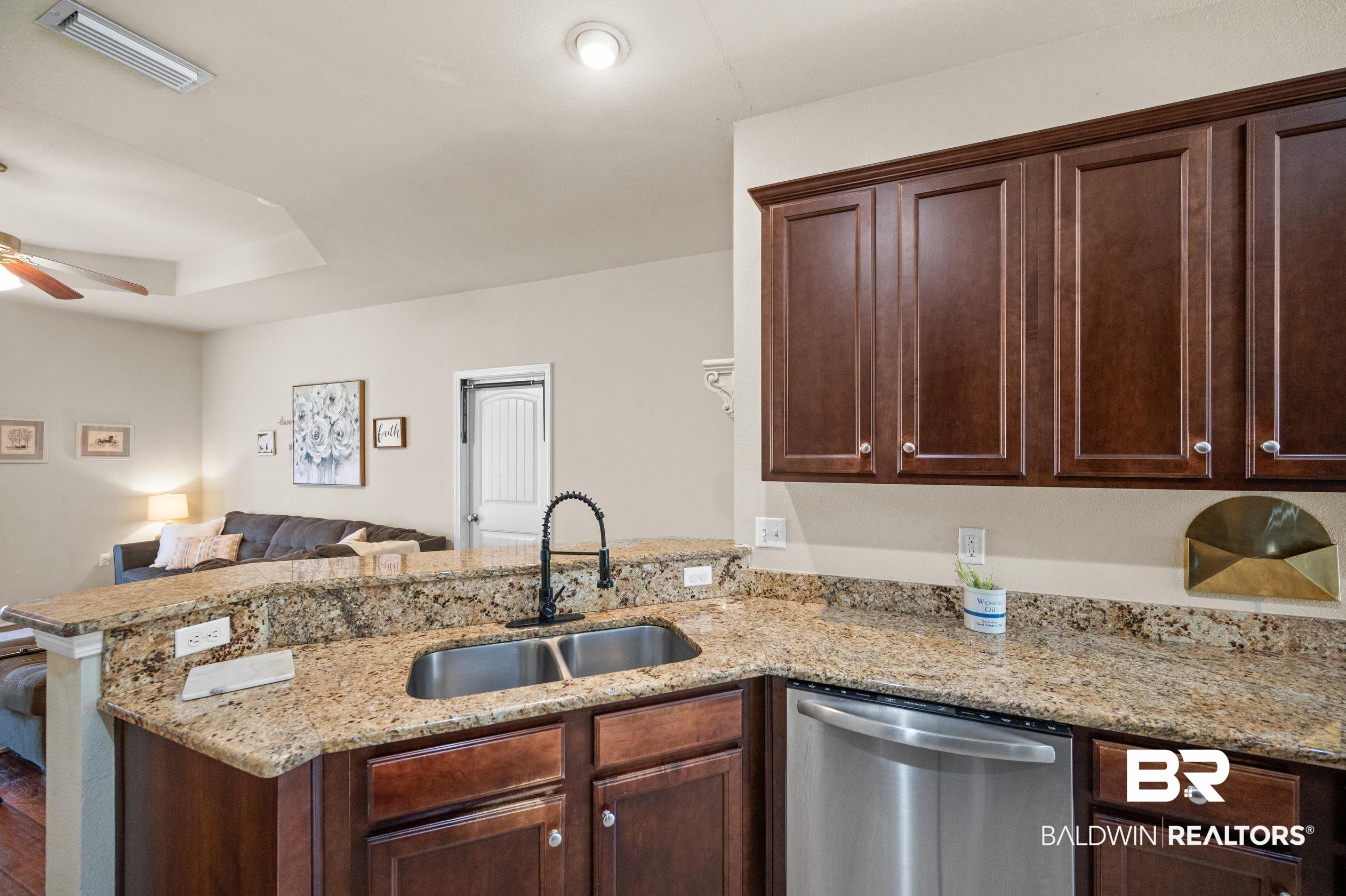 745 Bonaventure Street Fairhope, AL 36532 - Photo 9 of 36 Kitchen featuring ceiling fan, sink, kitchen peninsula, and stainless steel dishwasher