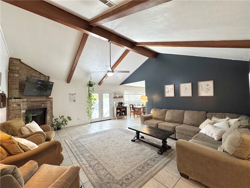 Living room featuring a textured ceiling, lofted c