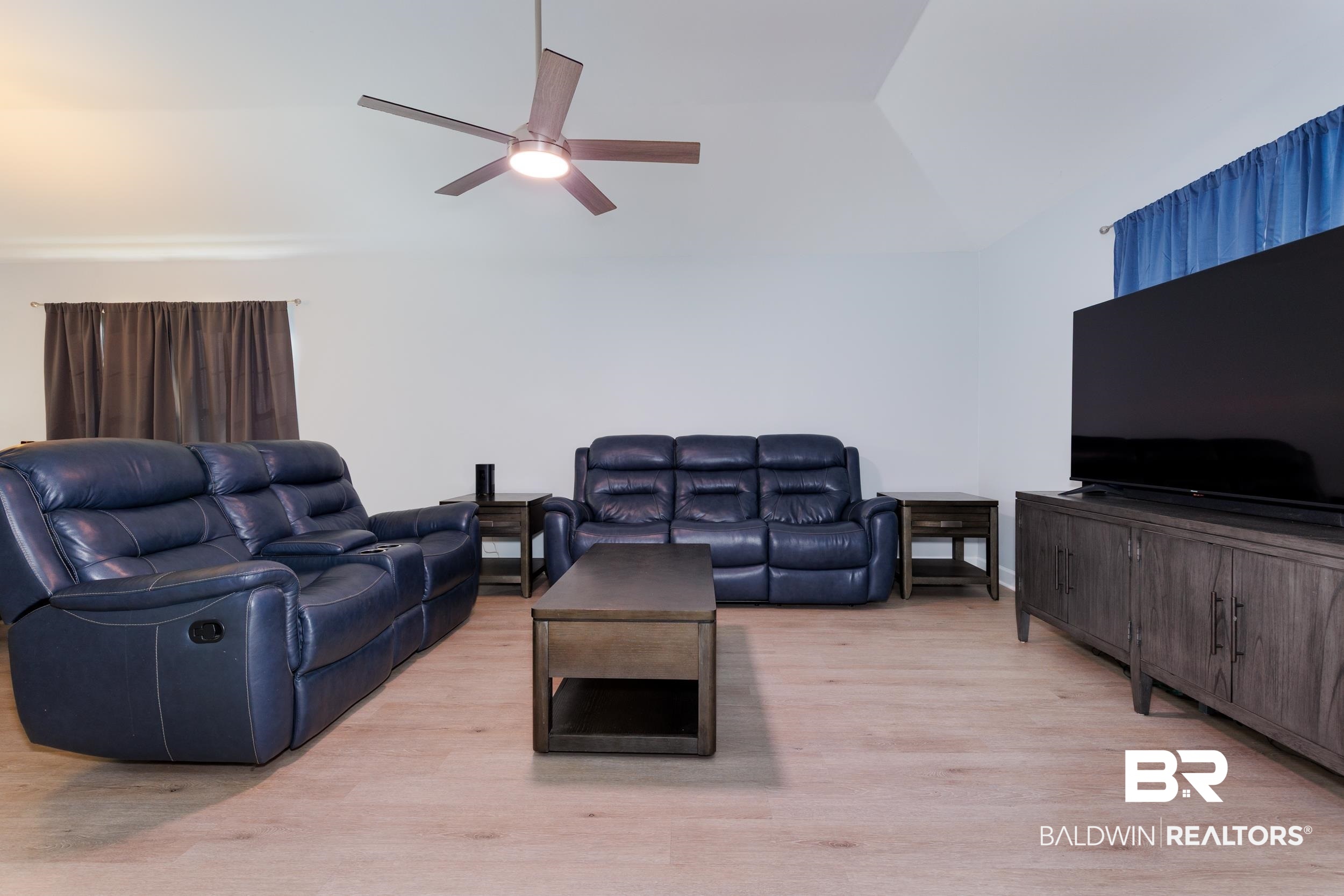 16227 Zenith Drive Loxley, AL 36551 - Photo 7 of 23 Living area with light wood-type flooring, vaulted ceiling, and a ceiling fan