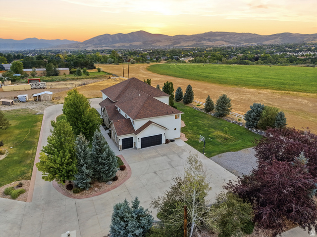 702 Alpine Highway Alpine, UT 84004 - Photo 10 of 83 Two-story residence with a multi-car garage, expansive concrete driveway, and mature landscaping