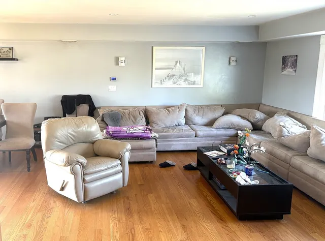 a living room with furniture and wooden floor