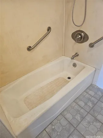 a bathroom with a tub and a shower