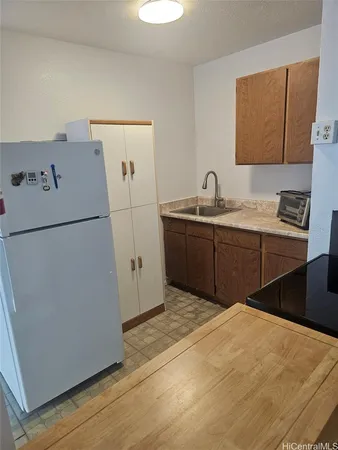 a kitchen with a refrigerator and a sink