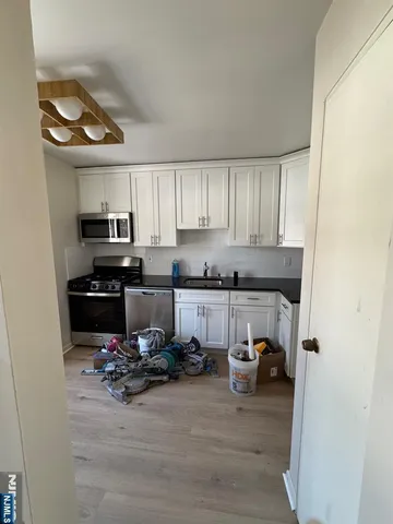a kitchen with a refrigerator and a stove top oven