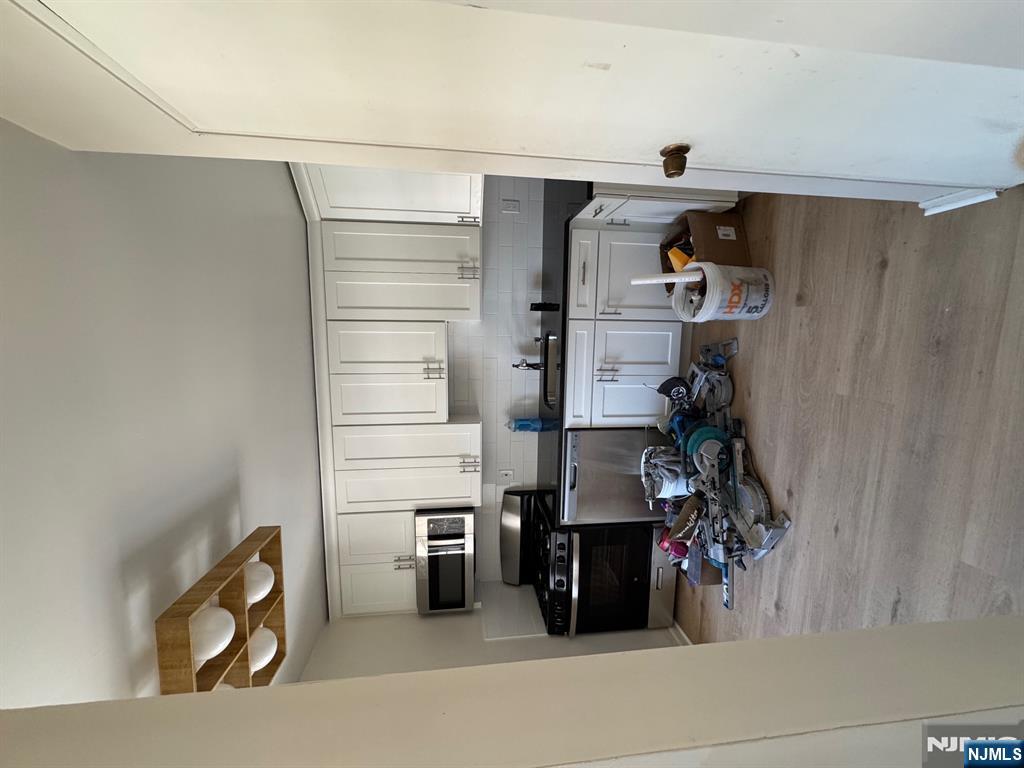 255 Piermont Road, Unit 6 Cresskill, NJ 07626 - Photo 2 of 9 a kitchen with a refrigerator and a stove top oven