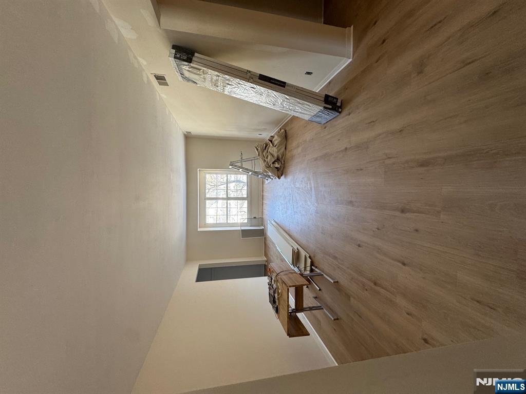 255 Piermont Road, Unit 6 Cresskill, NJ 07626 - Photo 3 of 9 a view of a room with gym equipment and a window