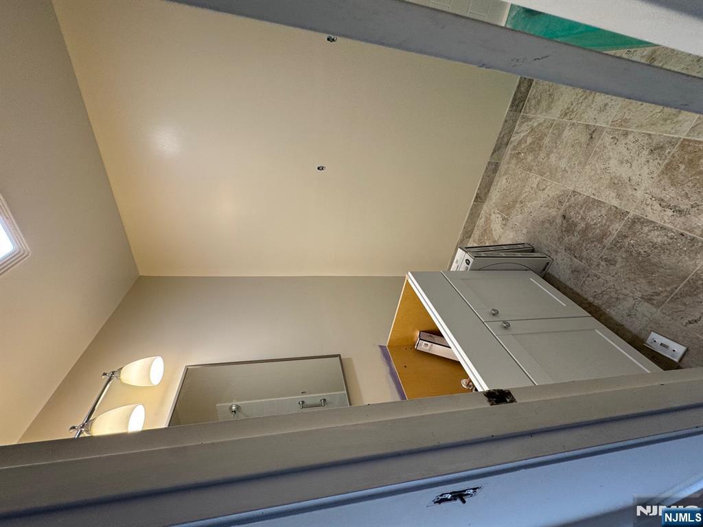 255 Piermont Road, Unit 6 Cresskill, NJ 07626 - Photo 4 of 9 a bathroom with a tub sink and mirror