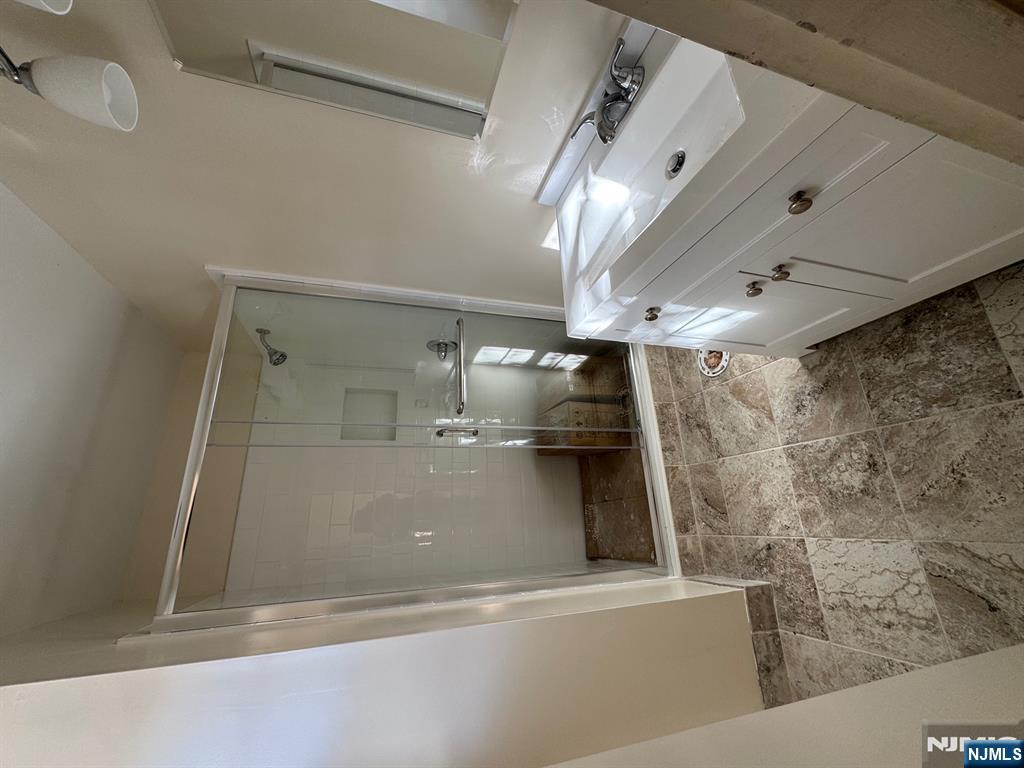 255 Piermont Road, Unit 6 Cresskill, NJ 07626 - Photo 6 of 9 a bathroom with a double vanity sink and a mirror