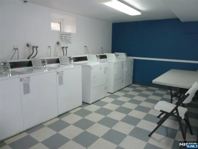 a room with a washing machine and a sink