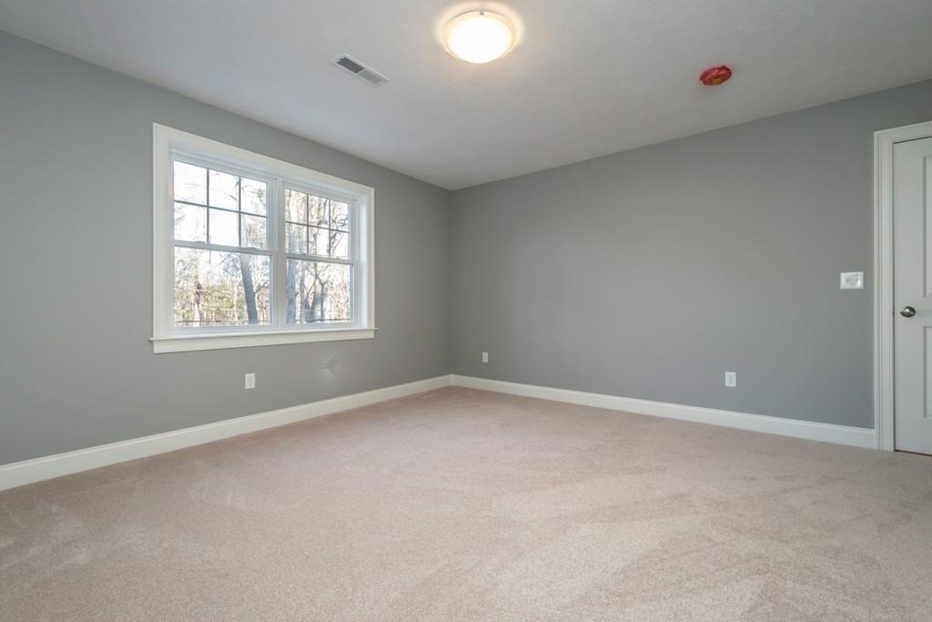 1120 Burroughs Road Boxborough, MA 01719 - Photo 32 of 42 an empty room with windows and closet