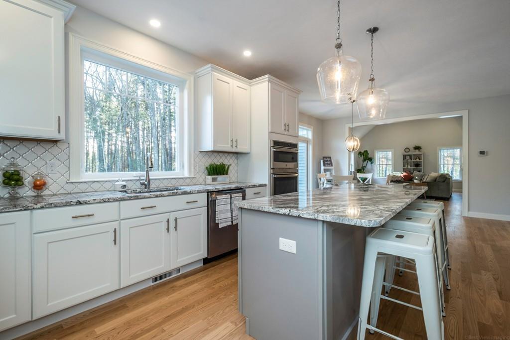 1120 Burroughs Road Boxborough, MA 01719 - Photo 8 of 42 a kitchen with center island and windows