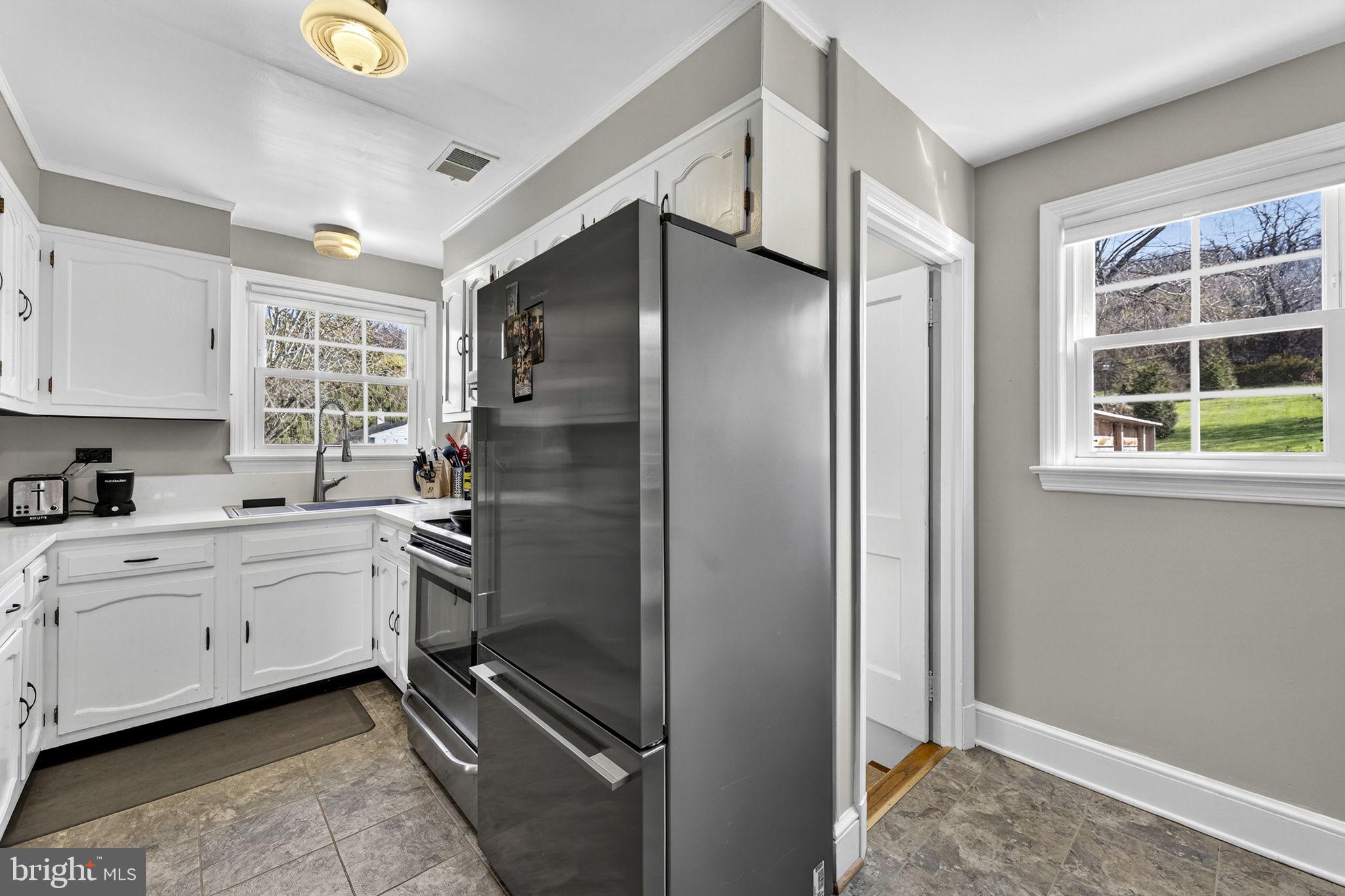 653 Federal Street Paris, VA 20130 - Photo 19 of 64 a kitchen with stainless steel appliances granite countertop a refrigerator and a sink